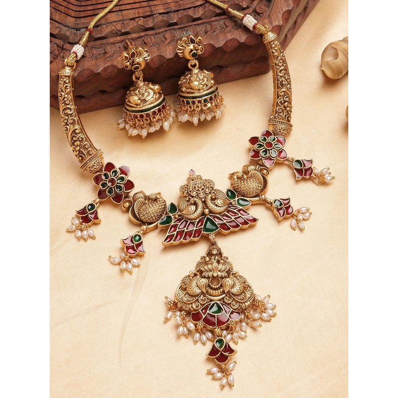 KARATCART Gold Plated Stone Studded and Beaded Engraved Laxmi Mata & Peacock Jewellery Set