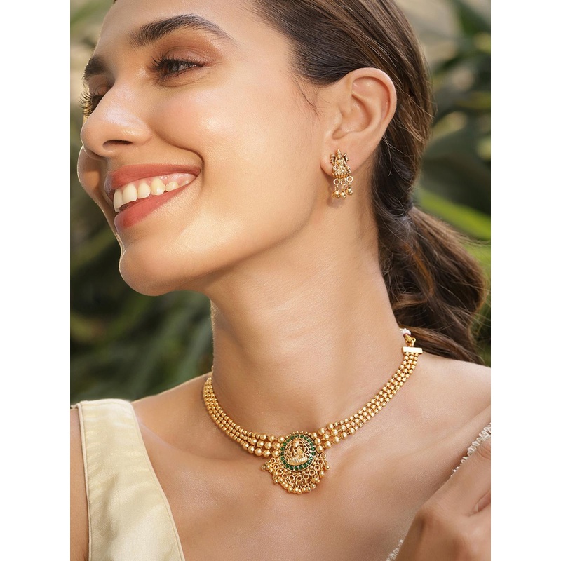 Rubans 22K Gold Plated Emerald Studed Gold Beaded Goddess Laxmi Motif Temple Jewellery Set